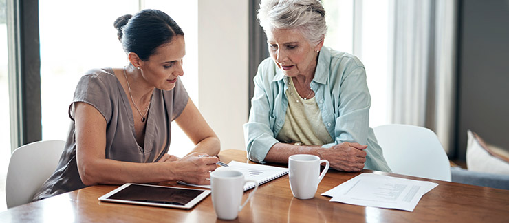 Support worker and resident reviewing plans at a table